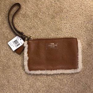 Coach clutch with fur piping